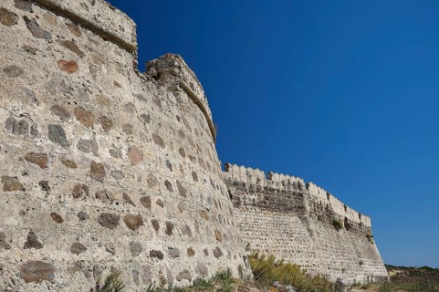 Close-up of massive stone wall building with clear blue sky, Antimacheia, Medieval Fortress, St