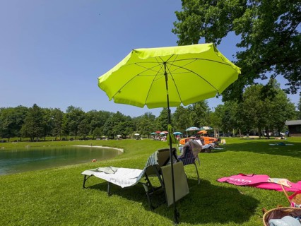 Sunshades and sunbeds by a lake
