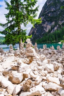 Cairn in front of a mountain lake, relaxing scene in nature, Pragser Wildsee, South Tyrol,