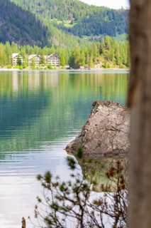 Lake with rocks in the foreground, mountainous landscape in the background, Pragser Wildsee, South