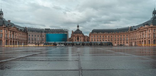 The stock exchange square in bordeaux, france, showcases its elegant architecture reflected on the