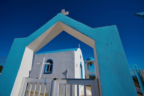 Chapel of Agios Charalambos, Blue and white Mediterranean church with an inviting entrance under a
