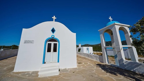 Chapel of Agios Charalambos, Traditional white chapel with bell tower and clear blue sky, Kefalos,