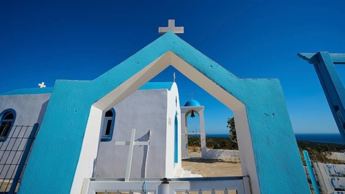 Chapel of Agios Charalambos, Blue and white Mediterranean church with clear sky and sea view,