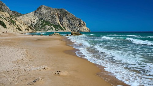 Beach, Kavo Paradiso, Paradise Beach, Extensive sandy beach with gentle waves under a blue sky,