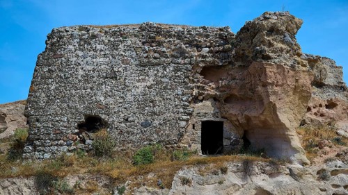Ruins of a castle, Dilapidated stone ruins with exposed walls, surrounded by natural landscape