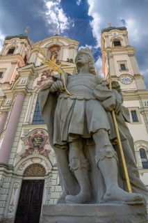 Sculpture of the church patron St Theodore in front of the east tower of the baroque Basilica of St