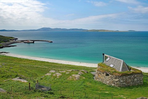 Expansive beach landscape with a lonely stone house and rolling hills in the background, Bonnie
