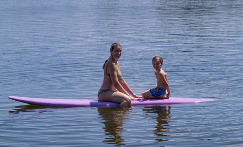 Mother, woman, blonde, in bikini and son, boy, 6 years, sitting on board, surfboard, surfboard,