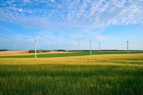 Wind turbines in a wide, green landscape with blue sky, summer, Höhefeld, Wertheim,