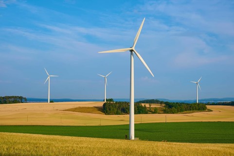 Wind turbines stand on fields stretching under a cloudy sky, summer, Höhefeld, Wertheim,