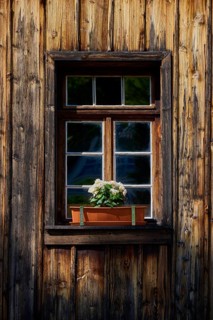 Rustic wooden window with flower box full of flowers in natural light, Triberg im Schwarzwald,