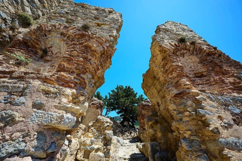 Two massive ancient stone arches open to a clear blue sky, Abandoned Village, Lost Place, Pyli,