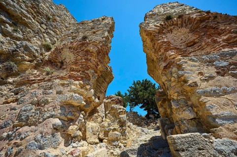 Two large ancient stone arches stand monumental against the blue sky, Abandoned Village, Lost