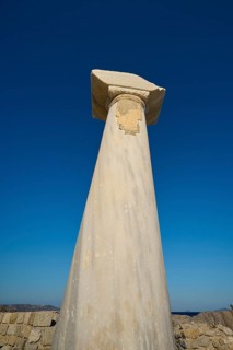 Close-up of an ancient column in front of a deep blue sky, Agios Stefanos Beach, Agios Stefanos