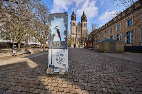 Part of the Berlin Wall, memorial to the fall of the Berlin Wall, cathedral, bare wintry trees,