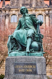Monument to Otto von Guericke, sandstone building, public order office, bare winter trees, historic