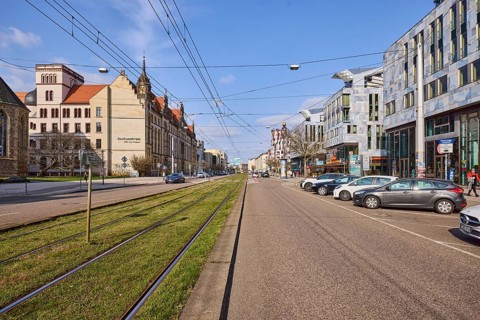 Street, parking boxes, tram tracks, overhead lines, general architecture, vehicles, blue sky,