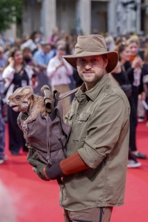 Actors with doll Dolores, which represents an aquilope from the Cretaceous period, at the German