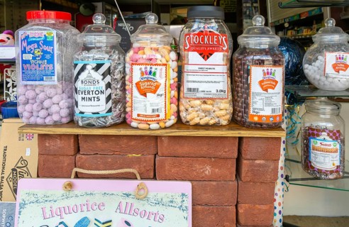 Jars of traditional sweets in shop window, Fisherton Street, Salisbury, Wiltshire, England, UK