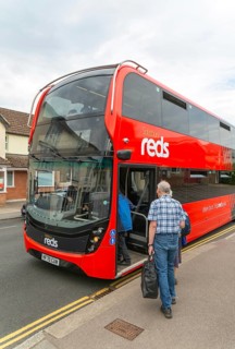 Passengers boarding Salisbury Reds double decker bus service X5 at Pewsey, Wiltshire, England, UK