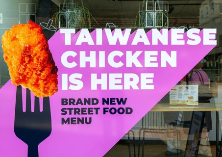 Taiwanese Chicken is here notice in shop window, Salisbury, Wiltshire, England, UK