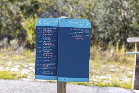 Sign at Campground Trail in Gulf State Park informs hikers of distance to various features within