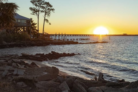 Sunset over the railroad bridge across Bay of Saint Louis from Henderson Point in Pass Christian,