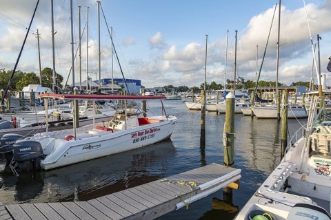 Dive boats and sailboats docked at Yacht Harbor Marina on Bayou Chico off Pensacola Bay in downtown