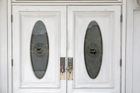 Etched glass entry doors to the Blue Bell Creameries Country Store and Ice Cream Parlor in