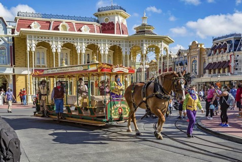 Horse pulling trolley car with Disney characters down Main Street in the Magic Kingdom at Walt