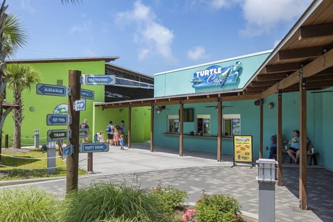 Sign outside the Turtle Cafe directs guests to different attractions at Ocean Adventures Marine