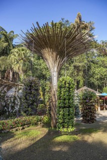 Fanned out column of bamboo holds hanging planters with colorful flowers at Mae Fah Luang Gardens