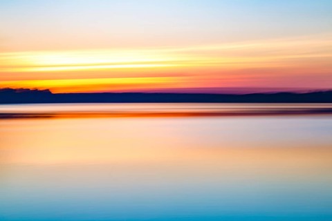Motion blurred abstract lake at sunset background or wallpaper