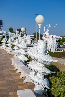 Ornate dragon sculptures around the perimeter of the Guan Yin (Goddess of Mercy) statue at Wat Huay