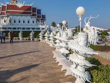 Ornate dragon sculptures around the perimeter of the Guan Yin (Goddess of Mercy) statue at Wat Huay