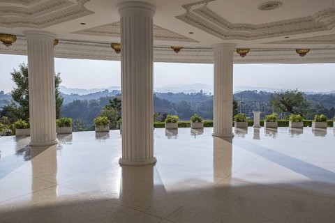 Hills beyond the supporting columns under the Guan Yin (Goddess of Mercy) statue at Wat Huay Pla