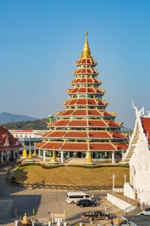 Nine tiered pagoda with gold dragons on each rooftop at Wat Huay Pla Kang in Chiang Rai, Thailand