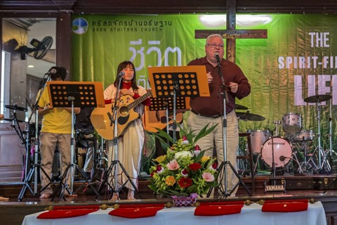 Pastor Michael Johnson speaking at the Baan Athitaan Church and Grace Language School in Chiang