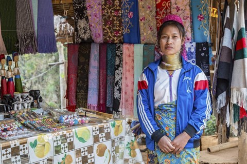 Tribal woman selling woven scarves and other crafts in the Long Neck Karen tribe (more properly
