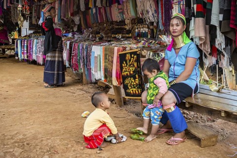 Tribal woman with two children in the Long Neck Karen tribe (more properly called the Kayah Lahwi