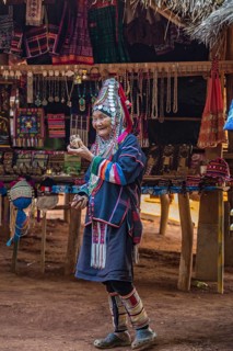 Elderly traditionally dressed woman selling art and craft items in the Akha tribe area of the Union