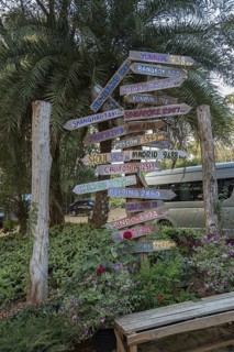 Sign post with arrows pointing to other places and showing the distance from Chiang Rai, Thailand