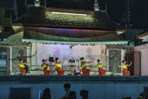 Traditional Thai dancers perform on a lighted stage at the night market in downtown Chiang Rai,