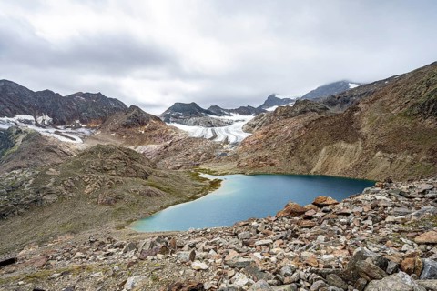 Mountain lake Vogelhüttensee, high mountain landscape with glacier Übeltalferner in the background,