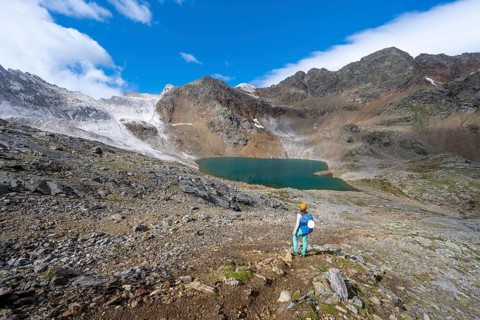 Mountaineer in front of mountain landscape with limestone rocks between granite mountains, mountain