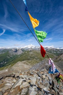 Böses Weibl summit with colourful prayer flags, view of picturesque mountain landscape with