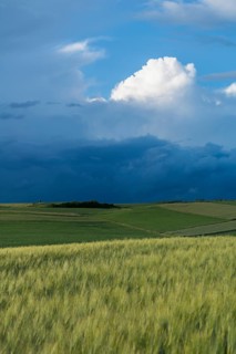 Dramatic cloudy sky with approaching storm and last rays of sunshine, Frankenhain, dark cloud wall,