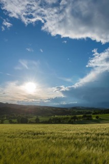 Dramatic cloudy sky with approaching storm and last sunbeams, Frankenhain, dark cloud wall,
