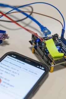 Close-up of a smartphone next to electronic components on a table, Nagold Youth Research Centre,